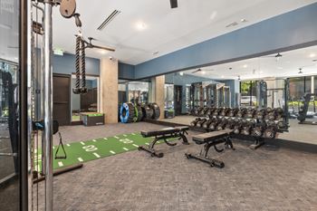 Cardio and strength training fitness center featuring echelon smart connect exercise bikes, hiit hub with trx suspension trainer, free weights